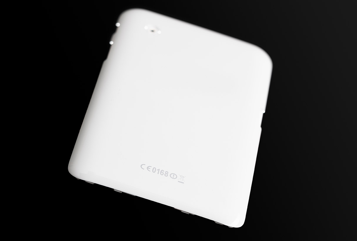 A white cover for a tablet that has been laser marked by color change.